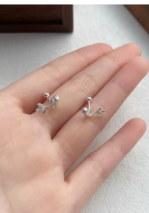 Close-up of S999 sterling silver koi fish stud earrings with screw ball backs