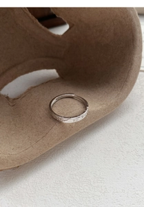 Detailed macro view of S999 silver ring featuring delicate butterfly and floral relief