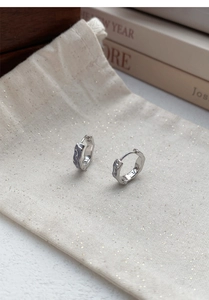 Detail of S925 sterling silver hoop earrings with irregular enamel drip and wave patterns