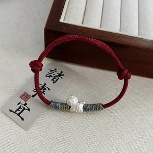S999 pure silver zodiac horse charm on a red braided rope bracelet with a New Chinese design