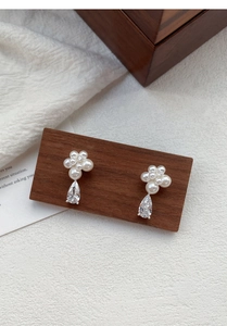 Detail of S999 silver pearl flower earrings with a pear-cut drop zircon gemstone