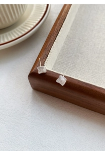 Macro shot of S925 sterling silver square stud earrings with brushed matte texture