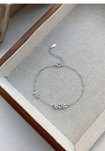 Detailed macro view of S925 sterling silver floral bracelet with light blue petal charms