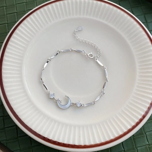 Elegant S925 sterling silver star and moon bracelet with zirconia on a ceramic plate
