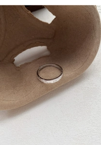 Detail of S999 silver ring featuring delicate engraved mountain and sun nature patterns