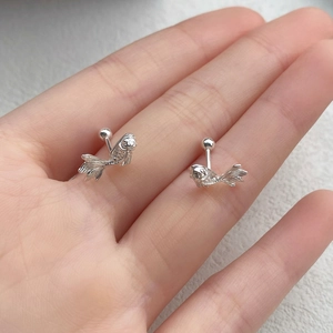 S999 sterling silver koi fish stud earrings held in hand to show exquisite scale details