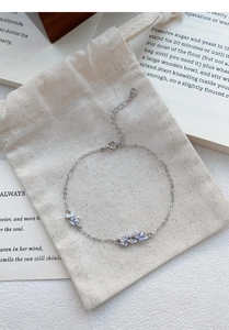 Macro shot of S925 sterling silver stamp on blue gradient flower bracelet with zircons