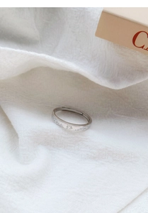 Close-up of S999 silver ring featuring detailed relief carvings of sun and wave patterns