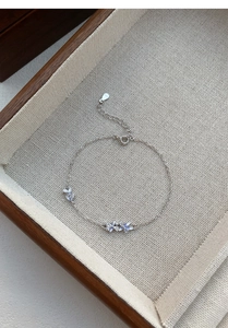 Detailed close-up of S925 silver bracelet featuring purple enamel flowers and white zircon