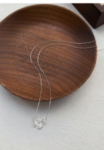 Detailed close-up of S999 sterling silver butterfly necklace with sparkling pavé crystals