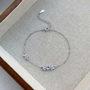 Elegant S925 silver bracelet featuring purple enamel flowers and sparkling zircon accents