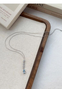 Detail of S999 silver necklace featuring a blue teardrop zircon and lobster clasp