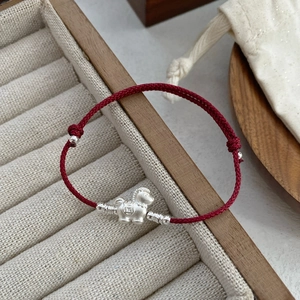 S999 silver horse pendant on red braided rope bracelet with traditional coin patterns