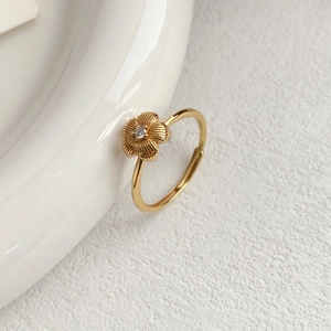 Exquisite S999 sterling silver flower ring with brushed gold finish and central zircon