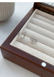 Close-up of S999 sterling silver cross hoop earrings with sparkling zircon inlay