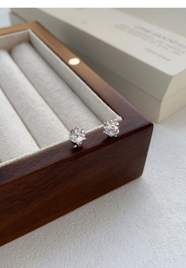 Macro shot of silver heart stud earrings with sparkling faceted heart-cut zirconia stones