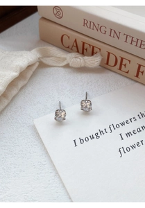 Close-up of elegant S999 silver rose-shaped earrings with six-prong set cubic zirconia