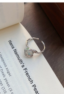 Macro detail of S925 sterling silver lava texture ring with colorful opal gemstone