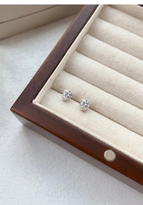 Macro detail of S999 silver heart stud earrings with zircon in tulip shaped setting