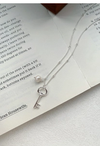 Detailed view of S925 silver key necklace with heart handle and freshwater pearl