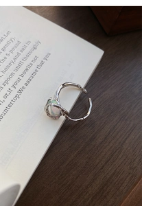 Macro detail of S925 sterling silver lava ring featuring an opal stone and branch texture