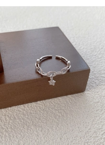 Gros plan sur la bague chaîne en argent S925 avec un pendentif étoile scintillant