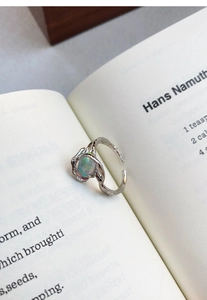 Macro view of S925 sterling silver ring featuring a liquid lava design with opal gemstone