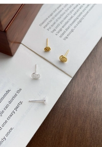Detailed close-up of S999 silver rose and prince stud earrings in gold and silver finishes