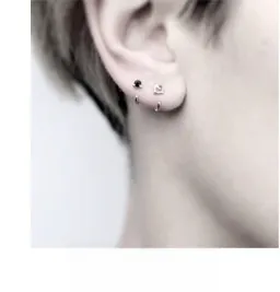Close-up of minimalist S925 sterling silver dolphin earrings worn on earlobe