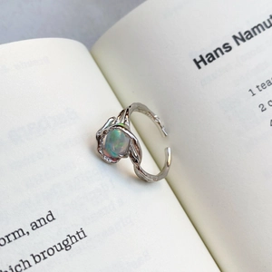Irregular S925 sterling silver lava ring with an oval opal stone on book pages