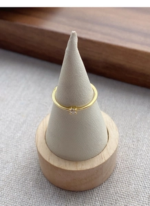 Close-up of a minimalist gold ring featuring a sparkling round cubic zirconia solitaire