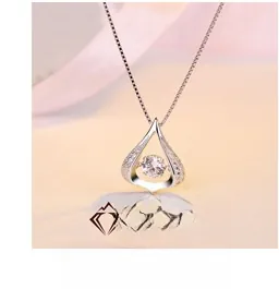 Detail showing an S925 silver water drop dancing stone necklace on pink silk fabric
