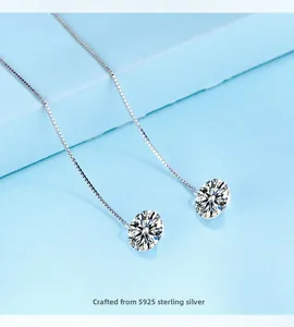 Macro detail of S925 sterling silver long tassel box chain earrings with shiny round stones