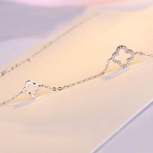 Macro shot of silver clover bracelet with pavé cubic zirconia and hollow design