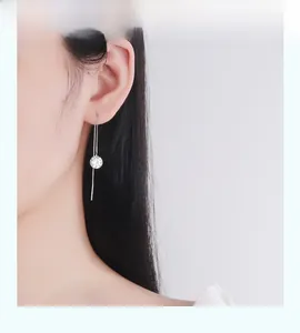 Detail of elegant S925 sterling silver drop earring with round sparkling cubic zirconia