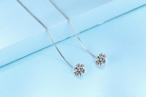 Detail of S925 silver long drop earrings featuring sparkling cubic zirconia stones