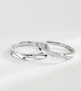 Detailed macro of S925 sterling silver couple rings with wavy texture and zircon inlays