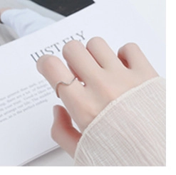 Close-up of minimalist S925 sterling silver wavy ring worn on finger for daily fashion