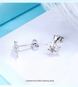 Macro shot of S925 sterling silver snowflake earrings with a center cubic zirconia stone