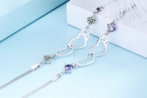 Detailed macro view of S925 sterling silver double heart bracelet with purple zircons