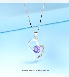 Detail of S925 sterling silver heart pendant with purple gemstone and small diamonds