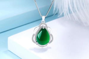 Macro shot of S925 silver necklace with pear-cut green chalcedony and zircon stones