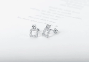 Detail of geometric S925 sterling silver stud earrings with sparkling pave zircon stones