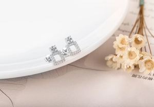 Macro shot of silver geometric square stud earrings with pave-set zircon crystals