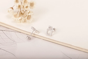 Detail of geometric S925 silver stud earrings with sparkling white cubic zirconia