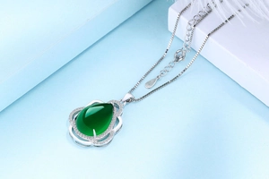 Detailed close-up of S925 sterling silver stamp on a green chalcedony drop pendant necklace