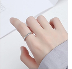 Detailed close-up of s925 silver minimalist heart-shaped rings for couples on a hand
