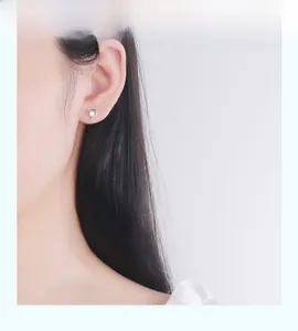 Nahaufnahme eines S925 Sterling Silber Herzohrrings mit Zirkonia, getragen von einem Model