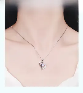 Elegant S925 silver heart necklace with purple gemstone and crystals worn by a model