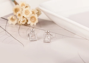 Macro detail of geometric S925 sterling silver square stud earrings with cubic zirconia